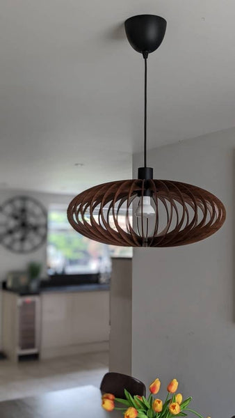 Customer photo (walnut): Ellipse wooden pendant light above a dining table