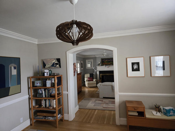 Customer photo (walnut): Medusa wooden pendant light in a hallway with an arched doorway