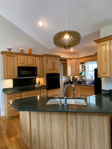 Customer photo (oak): Medusa wooden pendant light above a kitchen island