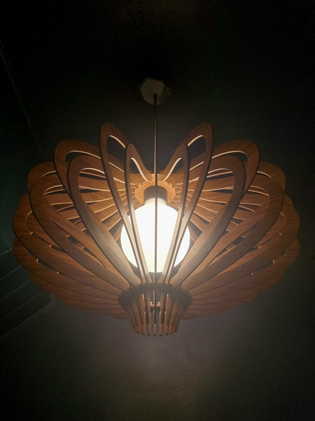 Customer photo (walnut): Medusa wooden pendant light lit at night