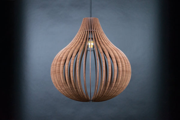 Bell wooden pendant light – tall bell-shaped slatted shade with a lit bulb, grey-blue background