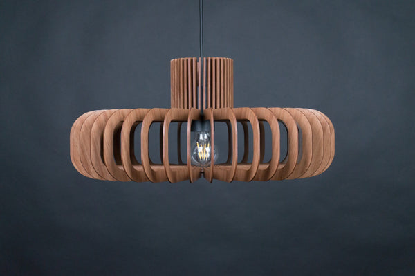 Disc wooden pendant light in walnut – wide drum of curved slats around a slatted centre, grey background