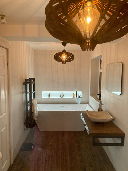 Customer photo (walnut): two Medusa wooden pendant lights above a freestanding bath